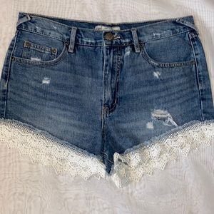 FREE PEOPLE Distressed Denim Shorts with Lace Accents